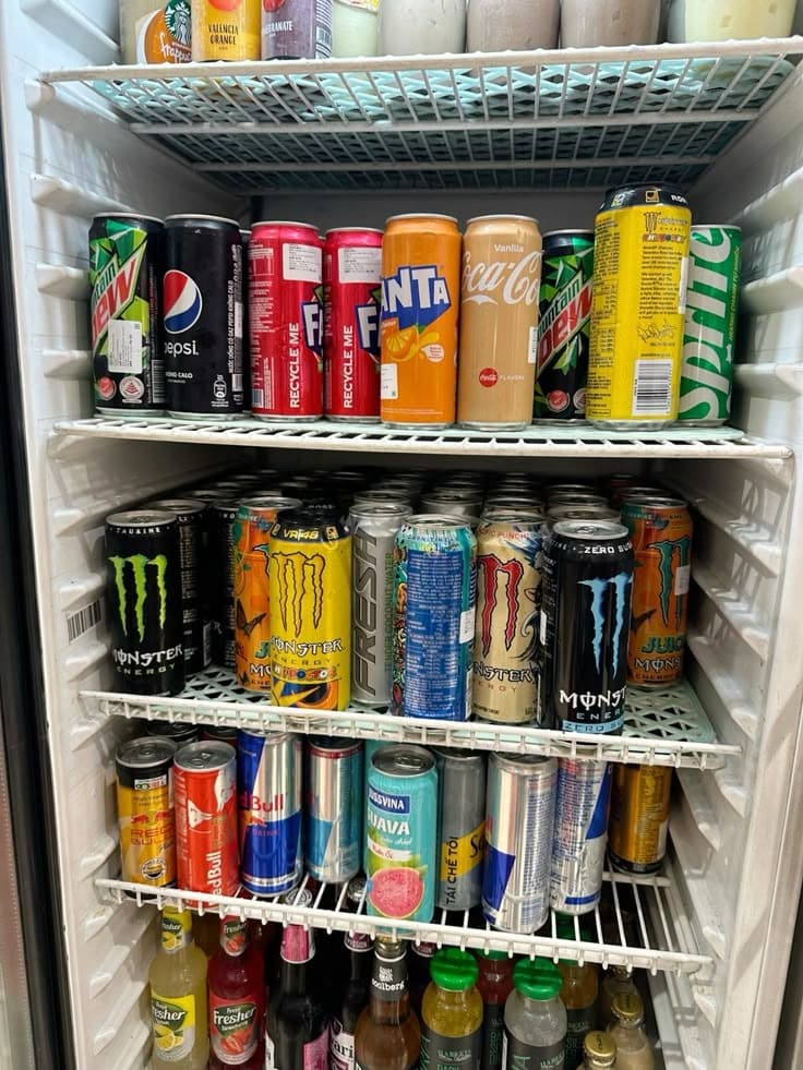 Office fridge stocked with energy drinks and sodas