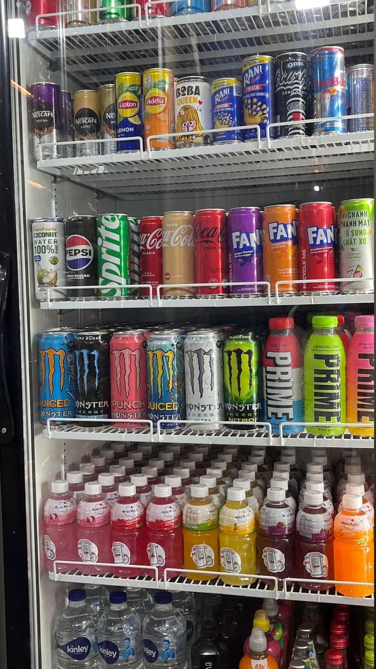 Office fridge stocked with assorted soft drinks
