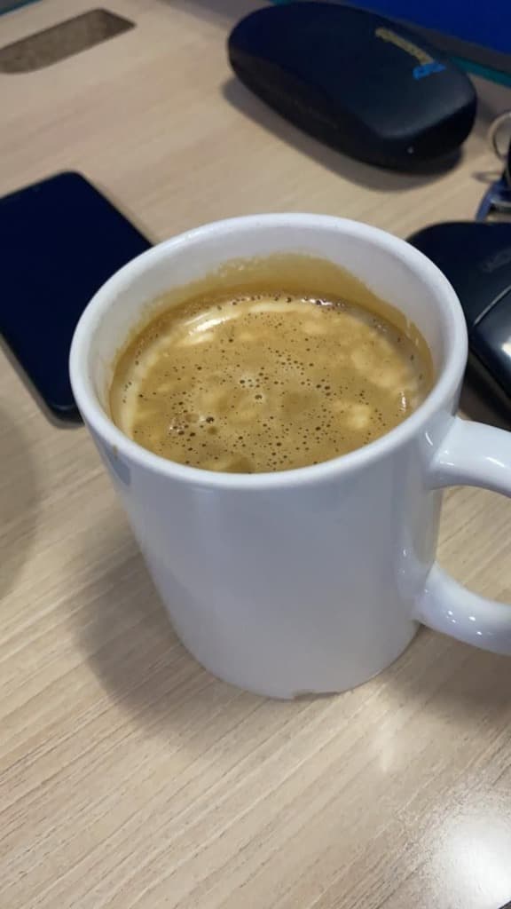 Nescafe red mug on a workstation